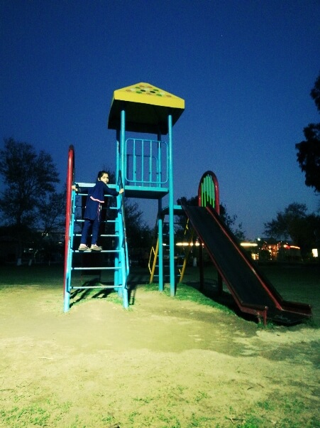 A girl playing in the park during evening