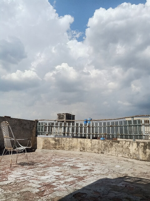 Beautiful clouds from a terrace and chair 