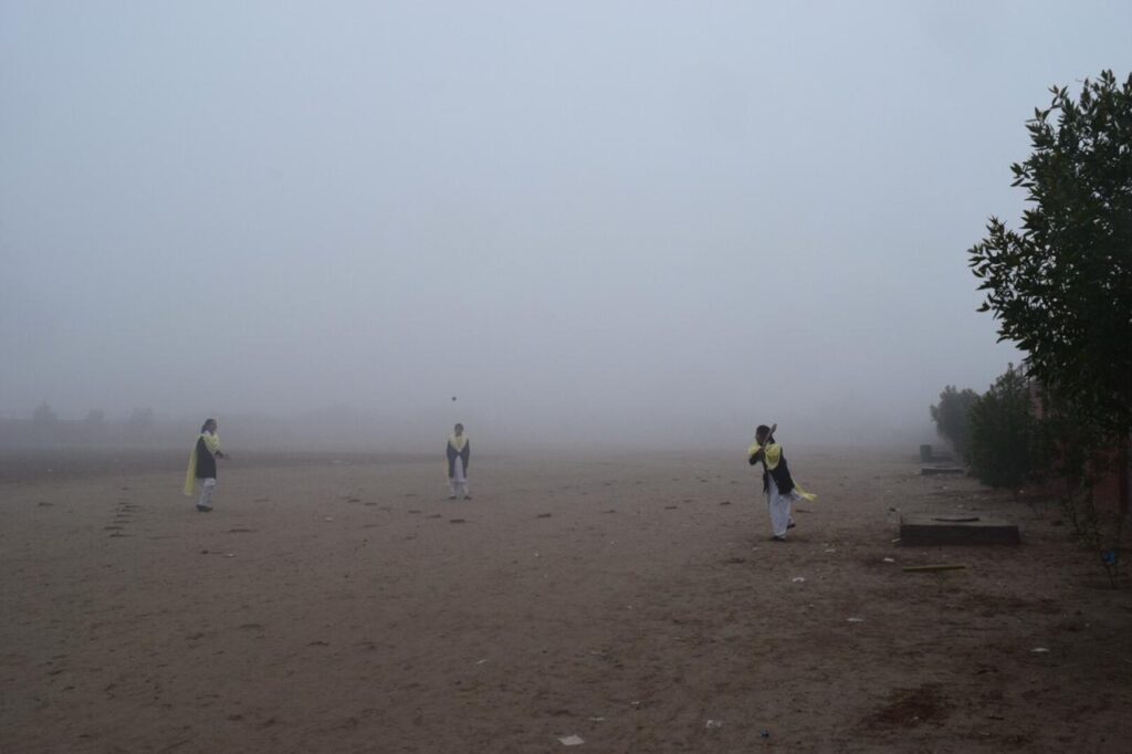 Girls playing cricket during fog in the ground