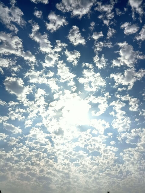 Sun with scattered clouds on sky