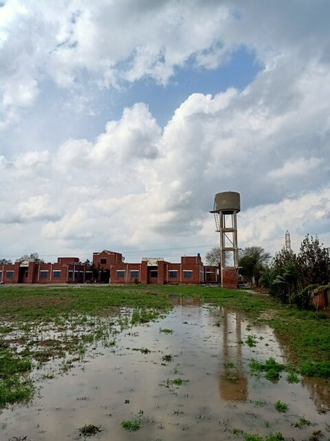 Cloudy sky with rain water in ground 