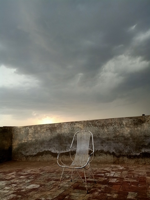 Cloudy weather view with a chair from rooftop