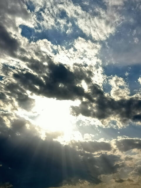 Sun rays through dark clouds 