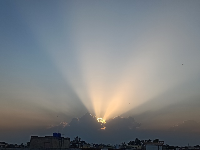 Sun rays from a cloud during sunset