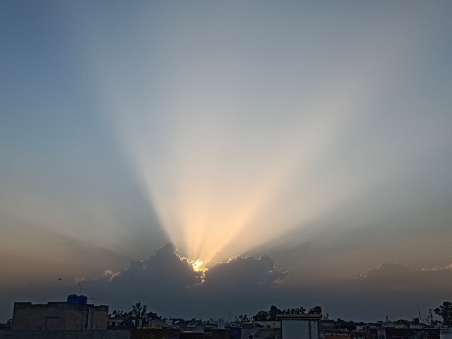 Sun beams through cloud in evening
