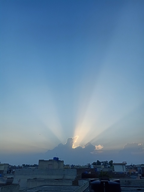 Attractive sun beams through a cloud 