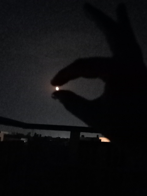 tiny moon between fingers