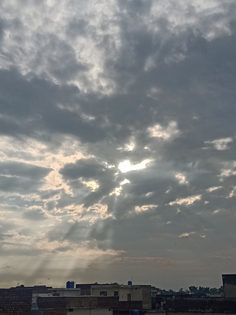Sun rays through grey clouds 