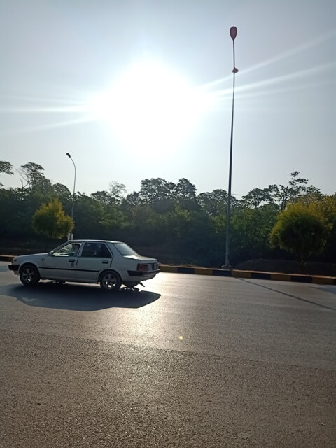 A car with sun on a road