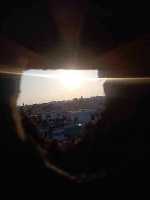 Sunset from a wall hole