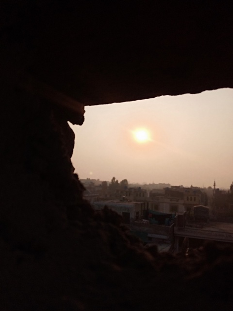 Sunset from a building wall hole