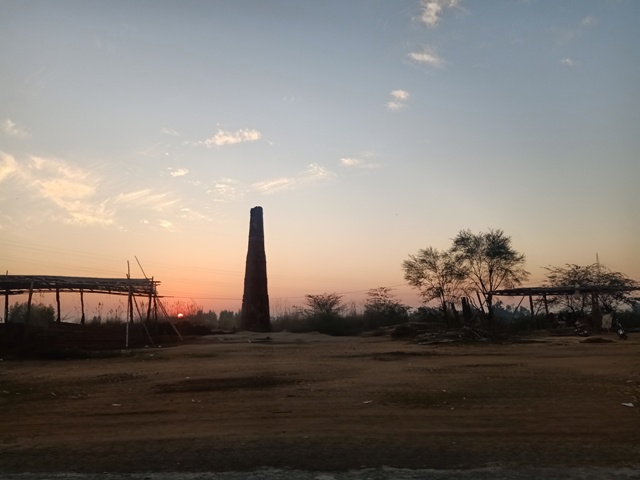 Sunset and brick kiln tower