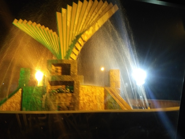 Yellow lights with fountain on a road
