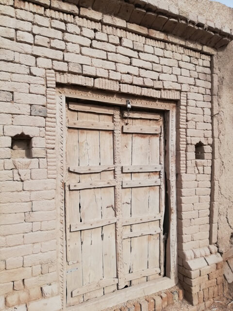 Wooden door in a mud building