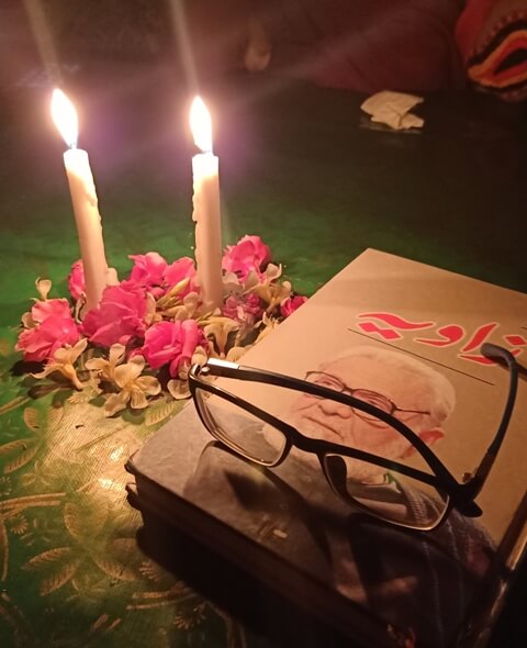 Colorful ambiance with flowers, candlelight, book and glasses