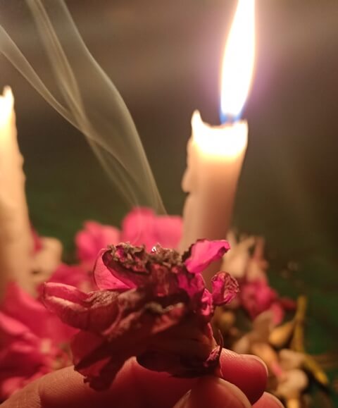 Burning flower with smoke and candle