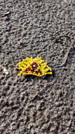 Colorful beads on sand