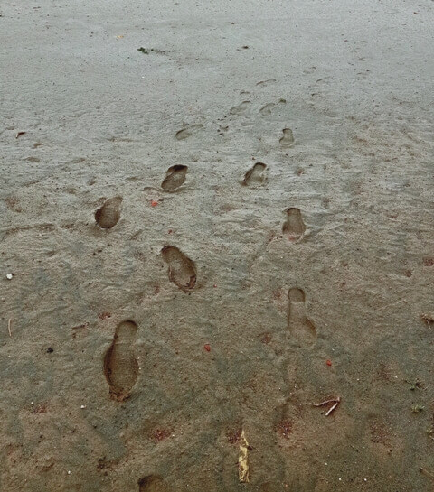 Feet impressions on ground after rain 
