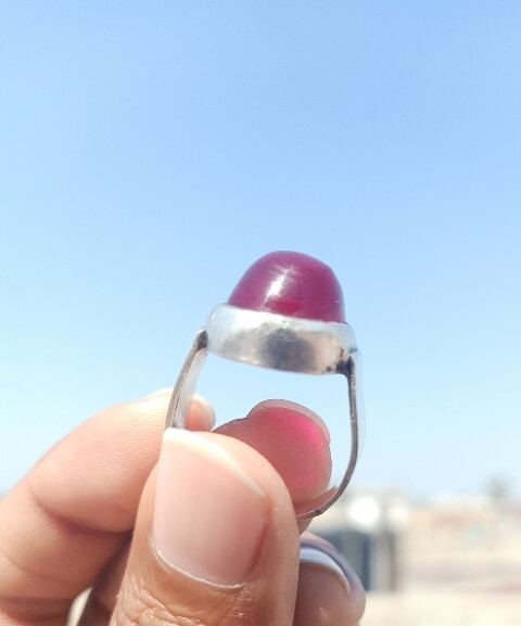 Ruby stone ring with sky in background