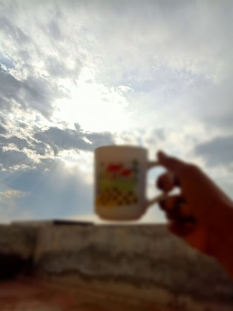 A cup of tea with cloudy sun view 