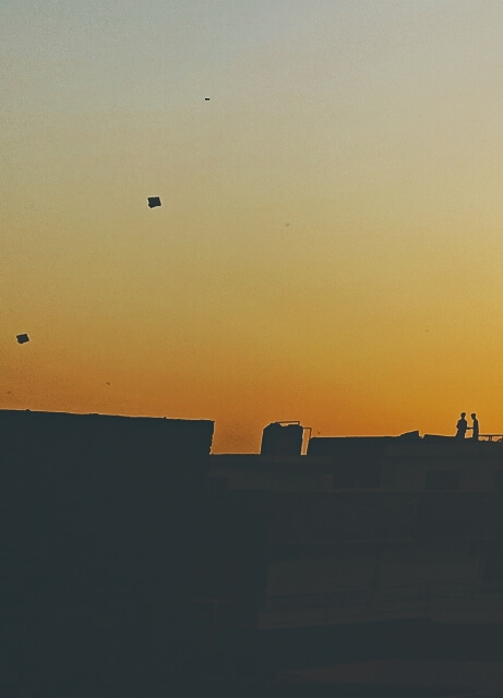 Boys playing on rooftop during golden hour