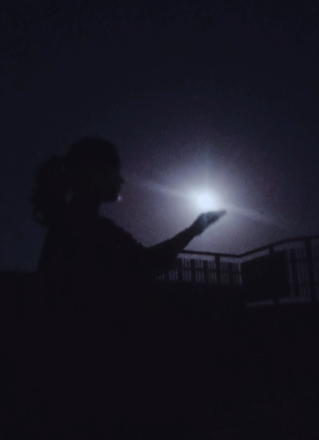 A girls shadow with full moon