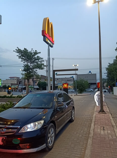 A drive through scene during evening
