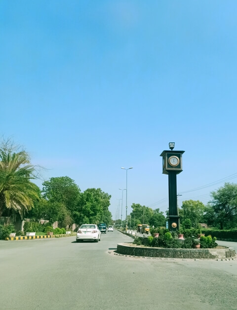 Sunny day on a road with chowk clock