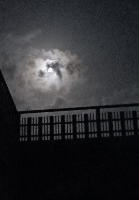 Moon and clouds on a rooftop