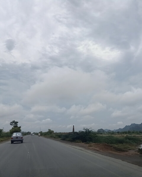 A cloudy road to city with mountains view