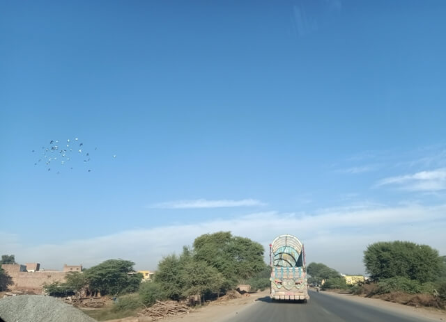 A truck with blue sky on a road