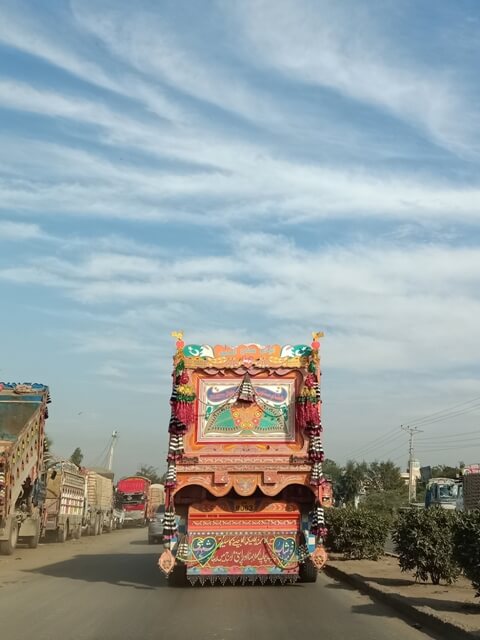 A traditional truck art with cloudy sky