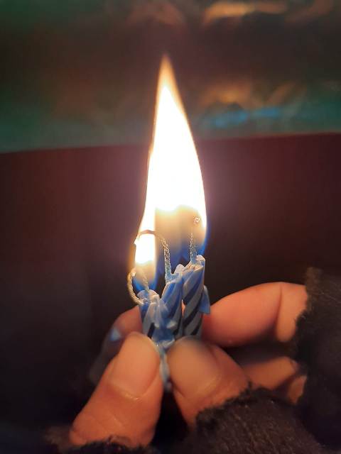 Tiny candles burning in hands