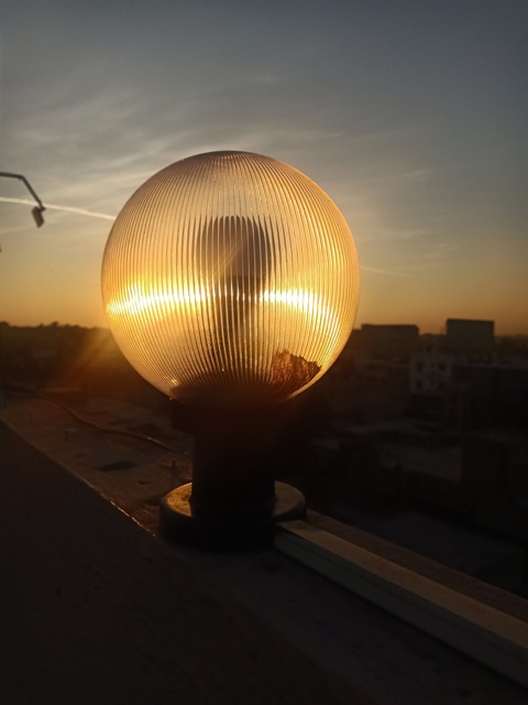 Sunset and a glass globe on a rooftop 
