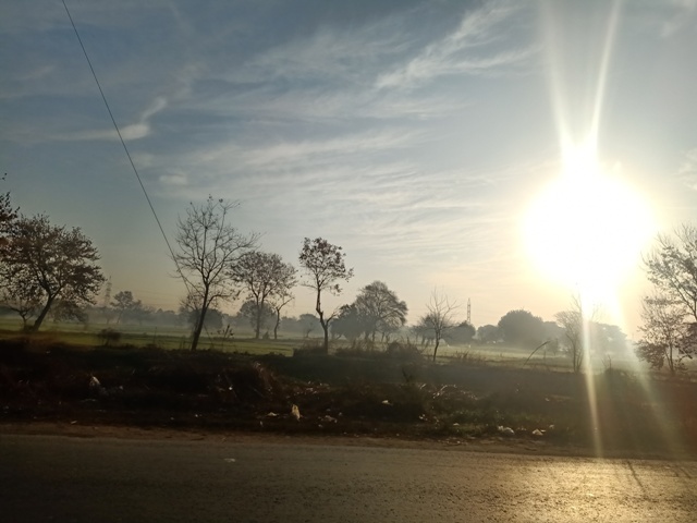 Road through countryside and sunrise 