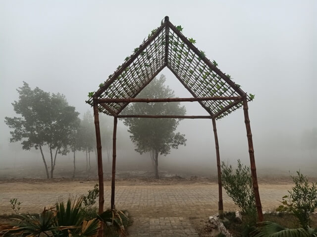 A garden structure with leaf decor in the foggy morning 