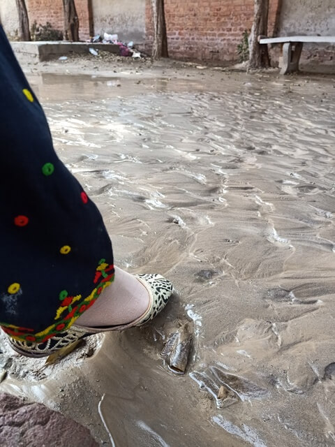 Foot on the river sand surface 