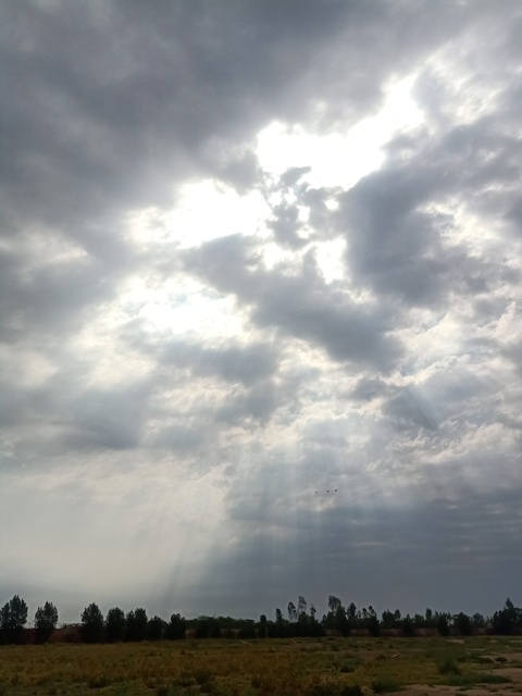 Sunbeams through grey clouds 